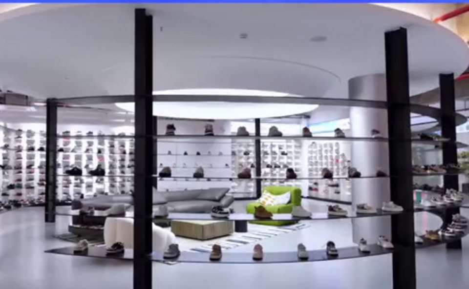 Wall of sneakers on display shelves in the partner's showroom